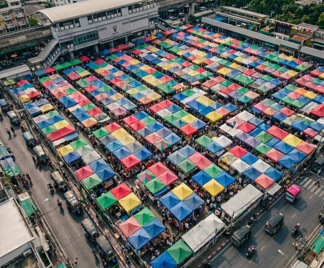 A high-angle view of the colorful canvas tents and shopping stalls at the open-air Chatuchak Weekend Market in Bangkok Thailand Chatuchak Weekend Market Stalls
