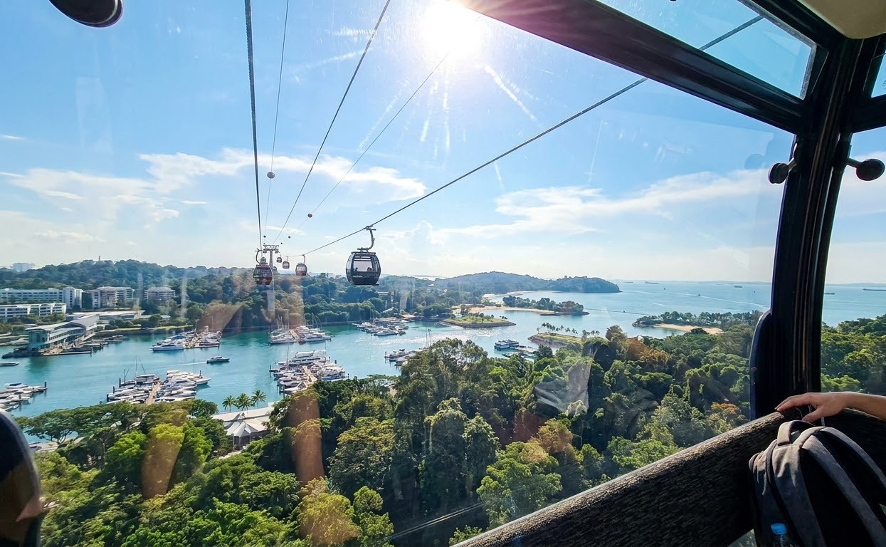 Scenic view from Singapore Cable Car looking over ocean harbour and rainforest
